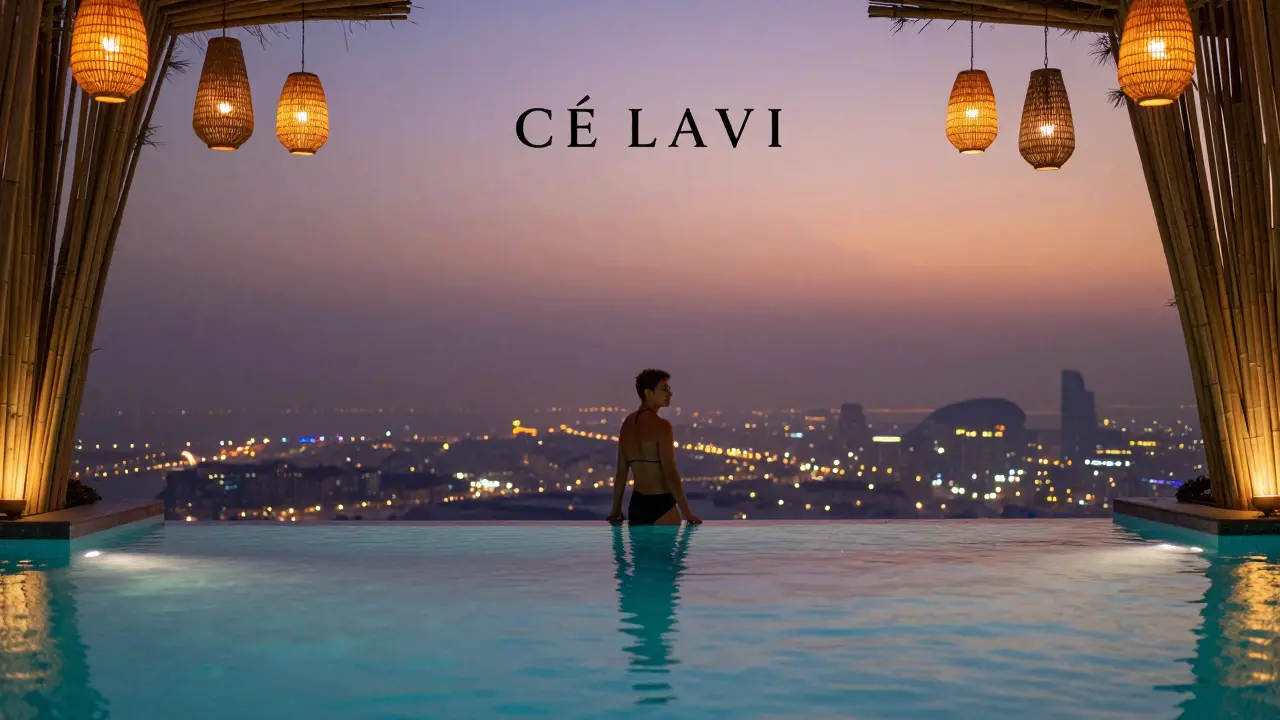 Infinity pool at CÉ LA VI Dubai at dusk, city lights glowing behind a silhouette by the water’s edge.